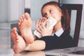 Portrait of very happy cute young business girl with bare feet on the table and counts money profit. Selective focus on feet Royalty Free Stock Photo