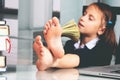 Portrait of very happy cute young business girl counts money profit. Selective focus on bare feet Royalty Free Stock Photo