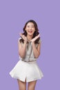 Portrait of very happy, jovial laughing beautiful young asian woman isolated against purple background Royalty Free Stock Photo