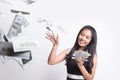 Portrait of very happy  young asian woman throwing out money banknotes Royalty Free Stock Photo