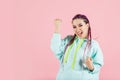 Portrait of very joyful fashionable dressed young girl on pink isolated background