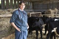 Portrait Of Vet In Barn With Cattle