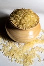 Portrait view of golden rice in a wooden bowl isolated on a white background. Rice is common food of Asian