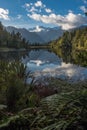 A portrait view of the incredibly beautiful Lake Matheson, New Zealand with the reflection of the stunning Southern Alps Royalty Free Stock Photo