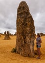 Portrait view of the limestone pinnacle in the Pinnacles National Park, Cervantes, Western Australia with a middle aged women