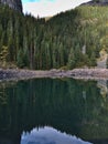 Portrait view of Mirror Lake near Lake Louise, Canada in the Rocky Mountains with colorful trees reflected in the water. Royalty Free Stock Photo