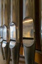 Portrait view of a rank of shining steel pipes of a refurbished church organ Royalty Free Stock Photo