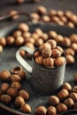 Portrait view of a vintage metallic dark grey mug and tray with hazelnuts