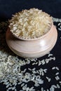 Portrait view of white rice in a wooden bowl isolated on a black background. Rice is common food of Asian p