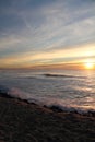 Portrait view of wonderful colorful scenery of atlantic ocean with breaking waves with mountain la rhune in sunset Royalty Free Stock Photo