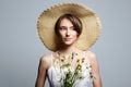 village girl in hat with flowers. beautiful young woman with chamomile Royalty Free Stock Photo