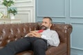 Portrait of vintage business blonde, white man person sleeping, resting, napping, and lying on sofa to sleep and relax. He is Royalty Free Stock Photo