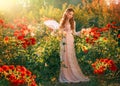 Portrait vintage lady fantasy girl medieval princess holding fan in hands waving enjoying wind green summer nature Royalty Free Stock Photo