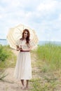 Vintage woman with parasol by the ocean Royalty Free Stock Photo