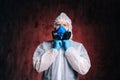 Portrait of virologist wearing coveralls, goggles and medical respirator.