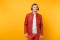 Portrait vogue happy fun young man in red leather jacket, t-shirt listen music in headphones isolated on bright trending Royalty Free Stock Photo