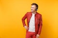 Portrait vogue happy fun young man in red leather jacket, t-shirt listen music in headphones isolated on bright trending Royalty Free Stock Photo