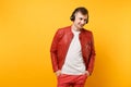 Portrait vogue happy fun young man in red leather jacket, t-shirt listen music in headphones isolated on bright trending Royalty Free Stock Photo