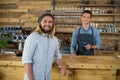 Portrait of waiter serving cup of coffee to man at counter Royalty Free Stock Photo