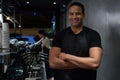 Portrait of waiter standing with arms crossed at counter Royalty Free Stock Photo