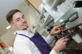 Portrait waiter using coffee machine