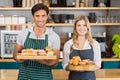 Portrait of waiter and waitress holding a tray of cupcakes Royalty Free Stock Photo