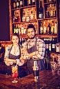 Portrait of waiter and waitress standing with arms crossed at counter Royalty Free Stock Photo