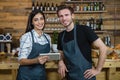 Portrait of waiter and waitresses using digital tablet at counter Royalty Free Stock Photo