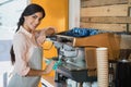 Portrait of waitress cleaning coffeemaker machine Royalty Free Stock Photo