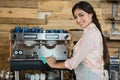 Portrait of waitress cleaning coffeemaker machine Royalty Free Stock Photo