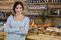 Portrait of waitress standing with arms crossed at counter Royalty Free Stock Photo