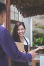 Waitress standing at the front of a cafe inviting people to come Royalty Free Stock Photo