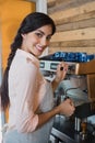 Portrait of waitress using coffeemaker Royalty Free Stock Photo