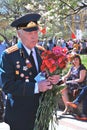 Portrait of a war veteran holding flowers.