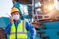 Portrait of warehouse asian man worker driver truck driver crane lifting up container with safety equipment standing in front of Royalty Free Stock Photo