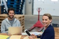 Portrait of warehouse managers using digital tablet and laptop Royalty Free Stock Photo