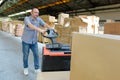 Portrait warehouse worker carrying boxes