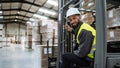 Portrait of warehouse worker driving forklift. Warehouse worker preparing products for shipmennt, delivery, checking Royalty Free Stock Photo