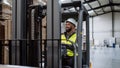 Portrait of warehouse worker driving forklift. Warehouse worker preparing products for shipmennt, delivery, checking Royalty Free Stock Photo