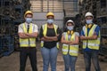 Portrait of warehouse worker. Group of factory industry worker working with face mask to prevent virus spreading during job