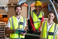 Portrait of warehouse workers and forklift driver