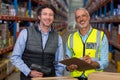 Portrait of warehouse workers standing with clipboard and barcode scanner Royalty Free Stock Photo