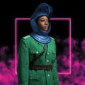 Military black woman dressed in helmet and coat
