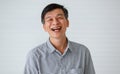 Portrait of warm personality senior older Asian man in casual dress friendly pose and laughing with happy and successful feeling