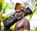 Portrait of a Warrior Asmat tribe with a ritual drum.