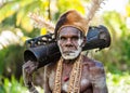 Portrait of a Warrior Asmat tribe with a ritual drum.