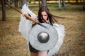 Portrait of a warrior woman in chain mail with steel bracers and wings behind her back.