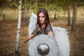 Portrait of a warrior woman in chain mail with steel bracers and wings behind her back.