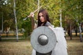 Portrait of a warrior woman in chain mail with steel bracers and wings behind her back.