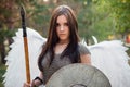 Portrait of a warrior woman in chain mail with steel bracers and wings behind her back.